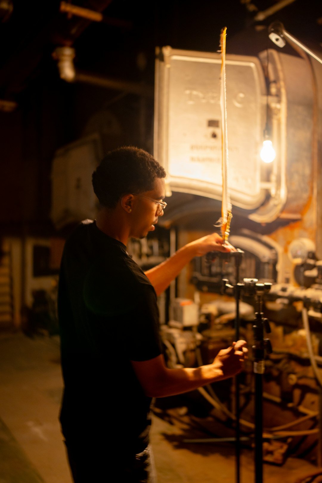 Technician checking microphone and lighting gear